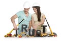 Establishing trust: Young smiling couple with machines building Royalty Free Stock Photo