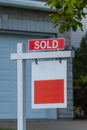 Estate agency SOLD signage. Real estate market property sold sign in front of new house. Copy space for Text. Royalty Free Stock Photo