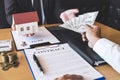 Estate agent broker receive money from client after signing agreement contract real estate with approved mortgage application form Royalty Free Stock Photo