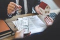 Estate agent broker receive money from client after signing agreement contract real estate with approved mortgage application form Royalty Free Stock Photo