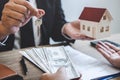 Estate agent broker receive money from client after signing agreement contract real estate with approved mortgage application form Royalty Free Stock Photo