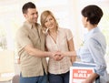 Estate agent congratulating couple Royalty Free Stock Photo