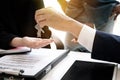 estate agent giving house keys to man and sign agreement in office Royalty Free Stock Photo