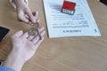 Estate agent giving house keys to owner and sign agreement in office Royalty Free Stock Photo