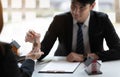 Estate agent giving house keys to woman and sign agreement in office Royalty Free Stock Photo