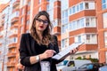 estate agent holding clipboard near new house Royalty Free Stock Photo