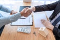 Estate agent shaking hands with customer after contract signature as successful agreement in real estate agency office. Concept of Royalty Free Stock Photo