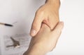 Estate agent shaking hands over white table with contract, keys and pen Royalty Free Stock Photo