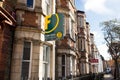 Estate agent signs outside a row of Victorian terraced houses