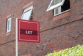 An estate agents let sign outside a block of flats where properties are for rent Royalty Free Stock Photo