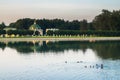 Evening view through the palace pond on the park pavilion `Grotto` in museum-estate Kuskovo, Moscow. Royalty Free Stock Photo