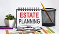 Estate Planning word with Notepad on white background with markers ,charts and glasses