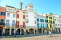 Este, Italy, 22 Apr 2017 - people walk under the colorful buildings in the main street of the italian Este village, province