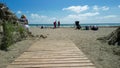 Estepona, Spain - April 7, 2023: Tourists along the beach on a beautiful spring morning