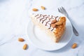 Esterhazy cake decorated with almonds in a plate