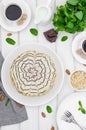 Esterhazy traditional cake with almonds and pralines on a white wooden background on a plate with a cup of coffee. Royalty Free Stock Photo