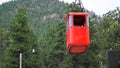 ESTES PARK, CO, U.S.A, JULY 8, 2018 - Red funicular coming down the mountain to load tourists on the tramway