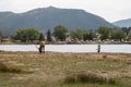 Fisherman takes photos of an elk grazing in the park near Lake Estes