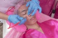 An Esthetician performs a Diamond peel facial, a type of microdermabrasion procedure. Exfoliating the skin of the cheeks and face