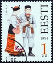 ESTONIA - CIRCA 1994: A stamp printed in Estonia from the `Folk Costumes` issue shows traditional clothing from Jamaja Royalty Free Stock Photo