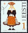 ESTONIA - CIRCA 1994: A stamp printed in Estonia from the `Folk Costumes` issue shows traditional clothing from Mustjala Royalty Free Stock Photo
