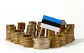 Estonia flag with stack of money coins