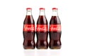 Estonia, Tallinn - 14.02.2021: Coca-Cola Classic in a glass bottle Isolated on white. three bottles of Coca-Cola