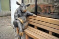 Sculpture of a bull sitting on a pebble in front of Goodwin The