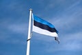 Estonian flag in blue sky.