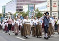 Estonian people in traditional clothing walking the streets of Tallinn