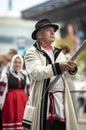 Estonian people in traditional clothing walking the streets of Tallinn