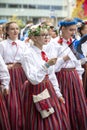 Estonian people in traditional clothing walking the streets of Tallinn