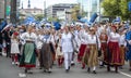 Estonian people in traditional clothing walking the streets of Tallinn