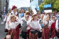 Estonian people in traditional clothing walking the streets of Tallinn