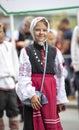 Estonian people in traditional clothing walking the streets of Tallinn