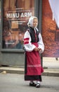 Estonian people in traditional clothing walking the streets of Tallinn