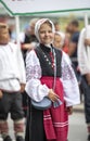 Estonian people in traditional clothing walking the streets of Tallinn