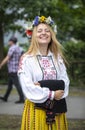 Estonian people in traditional clothing walking the streets of Tallinn