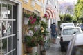 Estoril little street on summer time, colorful flowers in pots on the wall Royalty Free Stock Photo