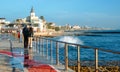 Spray from waves splashing on boardwalk leading to Tamariz beach in the Atlantic resort town of Estoril near Lisbon