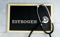 ESTROGEN wrote on chalkboard with stethoscope