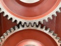 etail of two gearswheel of a machine on a red background, detail of case hardening, precision mechanics, gearing