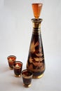 Etched amber glass decantor with three glasses.