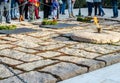 Eternal Fire at President J.F. Kennedy Grave Site in Arlington National Military Cemetery. Visitors are Paying their Respects