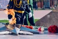 Eternal flame at the memorial to the unknown soldier. In the background, in blur, are men in full dress military uniform Royalty Free Stock Photo