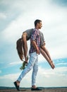 Eternal love. man and woman on their way. Problems in relations. man carries a girl on sky. outdoor walking. tired after