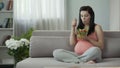 Eternally hungry pregnant girl eating salad, saturating body with vitamins