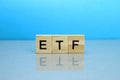 ETF word made of wooden blocks on a blue background Royalty Free Stock Photo