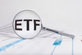 ETF word in magnifying glass. Investment, finance, business and stock market trading concept. Exchange-traded fund Royalty Free Stock Photo