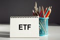 ETF - word on a paper with colorful pencils. A bright solution for business, financial, marketing concept